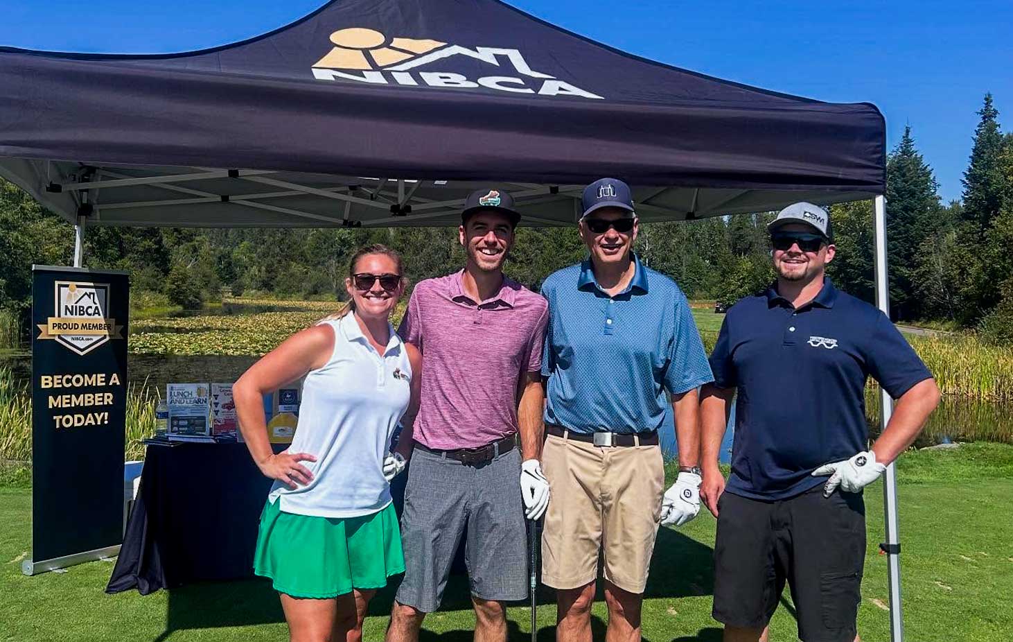 NIBCA latest news image showing a golf group in front of the NIBCA tent